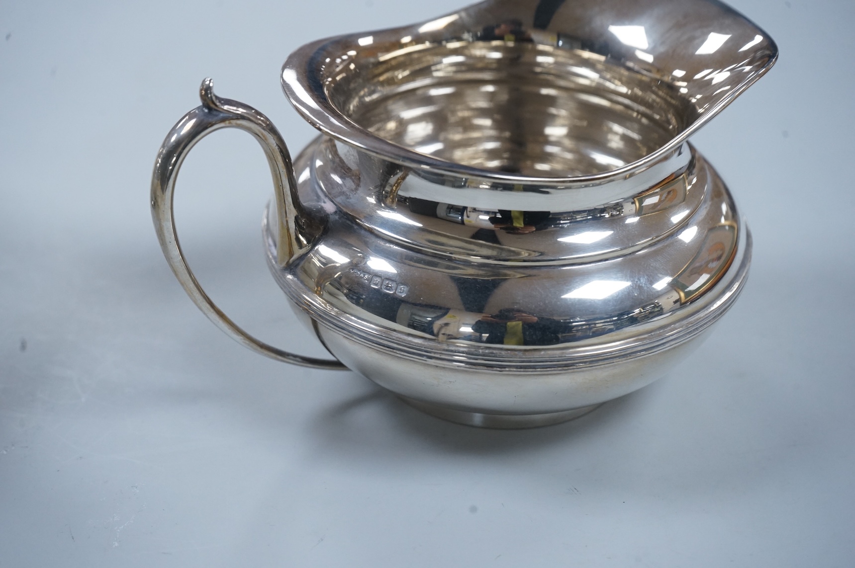 A George V three piece silver tea set, each piece of compressed globular form by James Dixon and Sons, Sheffield 1910, 1025g gross